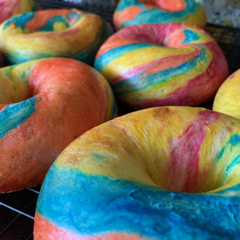 pink, yellow, blue and orange rainbow bagels